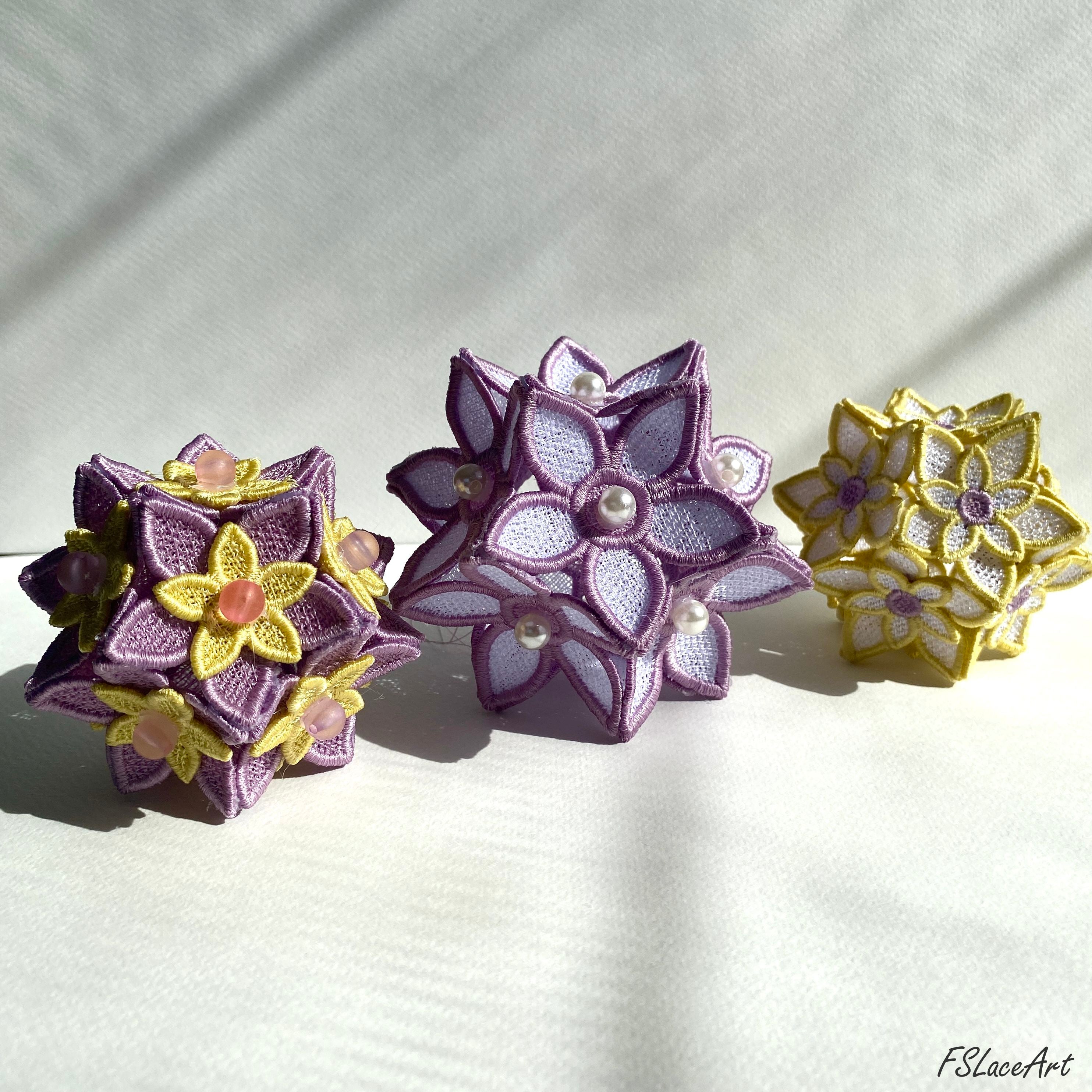 Three finished 3D FSL floral balls in lilac, purple and yellow thread color combinations