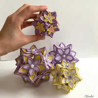 Four finished 3D FSL floral ball ornaments with layered flowers and decorative bead centers