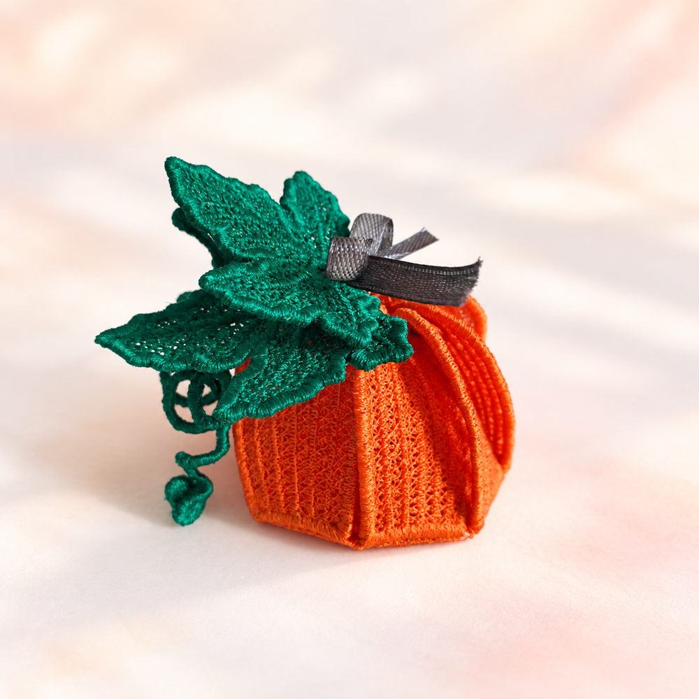 Finished orange 3D Pumpkin FSL gift box with green lace leaves, curling vines and a gray ribbon closure