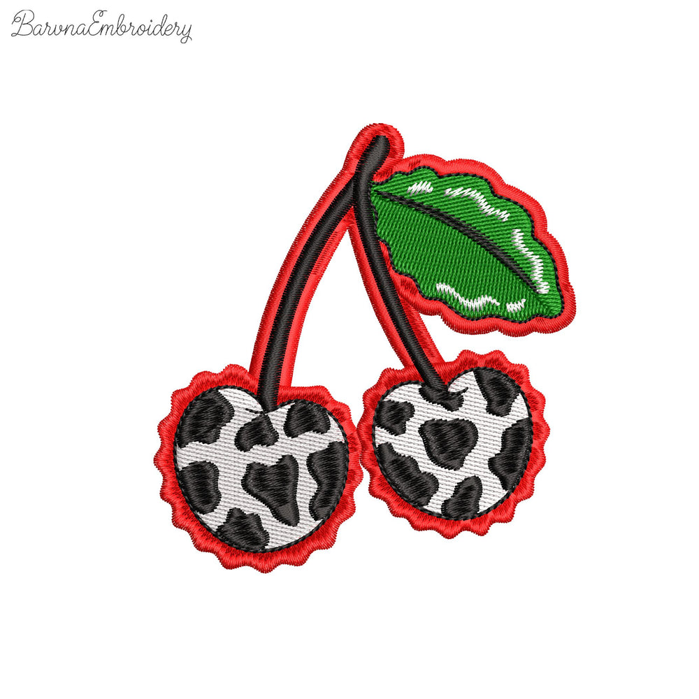 Two cherries with cow print texture and green leaves, finished with a wavy red border embroidery design.