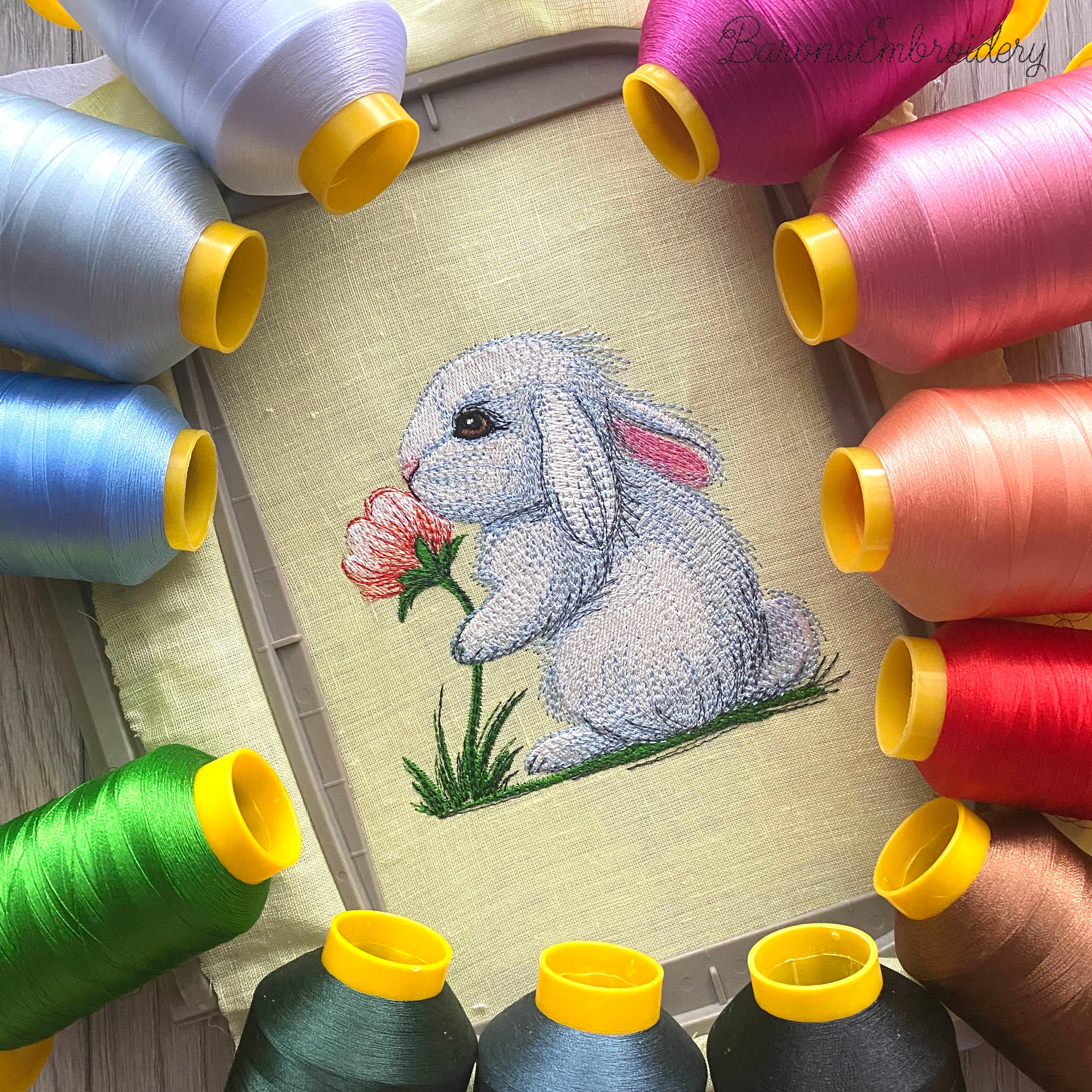 Cute bunny machine embroidery design sniffing a flower, soft spring animal embroidery pattern for kids and creative projects