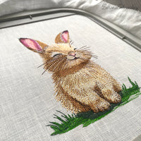 Cute bunny machine embroidery design sitting on grass, spring animal embroidery pattern for kids and seasonal projects