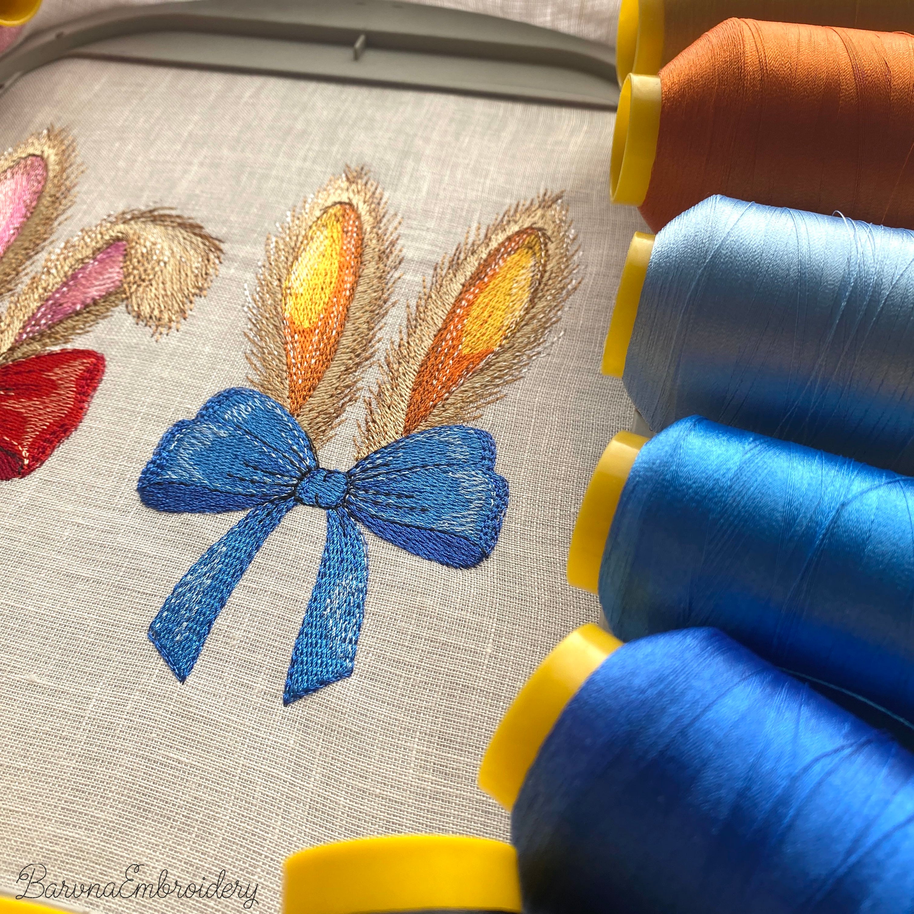 Machine embroidery design of bunny ears with blue bow, realistic fur texture, detailed embroidery stitches