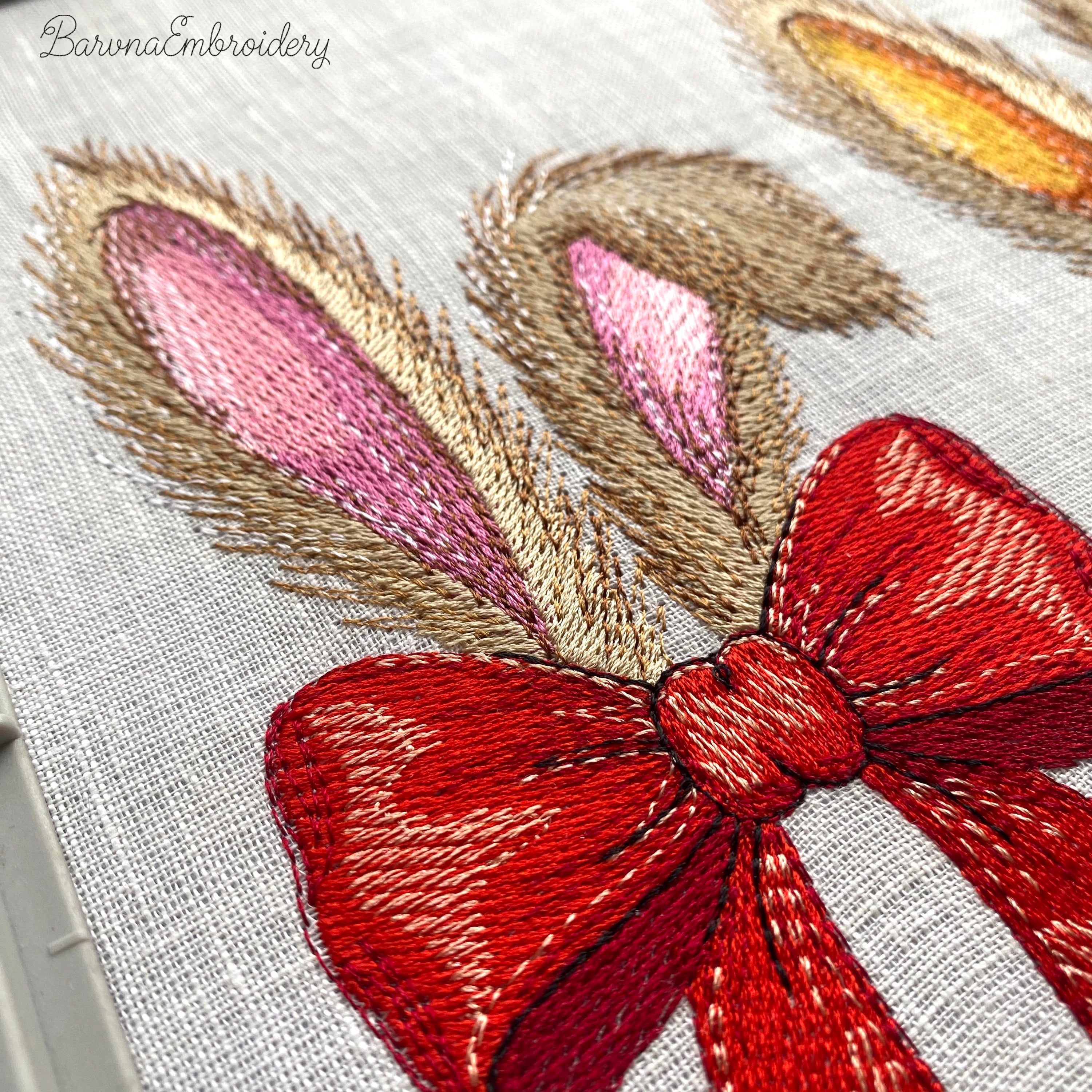 Machine embroidery design of bunny ears with red bow, fluffy fur texture, detailed stitches, embroidery design on dark background.