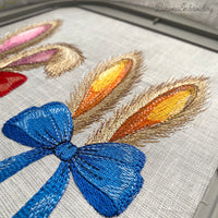 Machine embroidery design of bunny ears with blue bow, realistic fur texture, detailed embroidery stitches