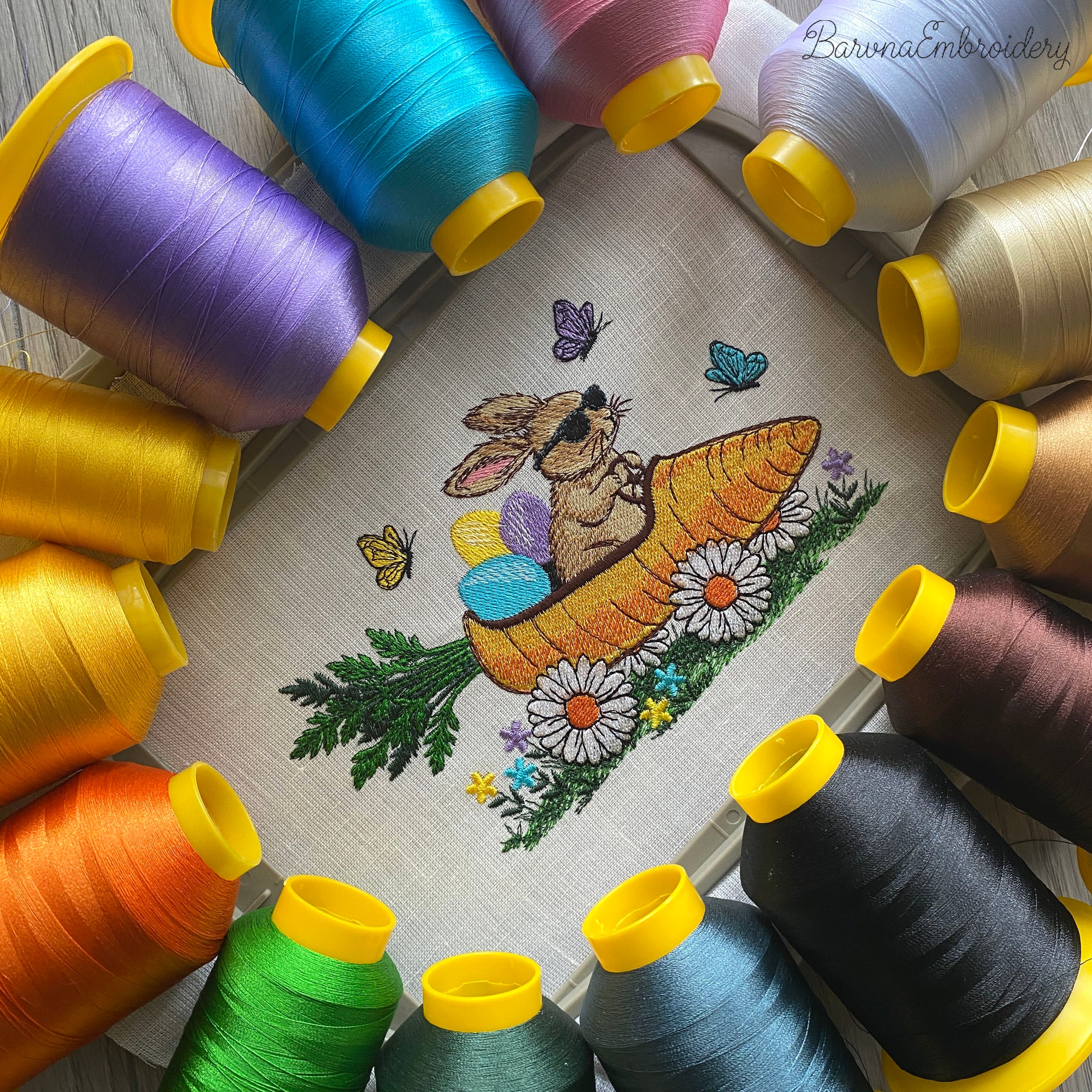 Funny Easter bunny embroidery design with spring theme, rabbit riding carrot with eggs and flowers, colorful machine embroidery file.