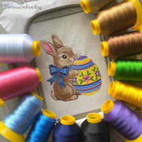 Cute Easter bunny with blue bow hugging decorated egg, spring machine embroidery design digital file for instant download.