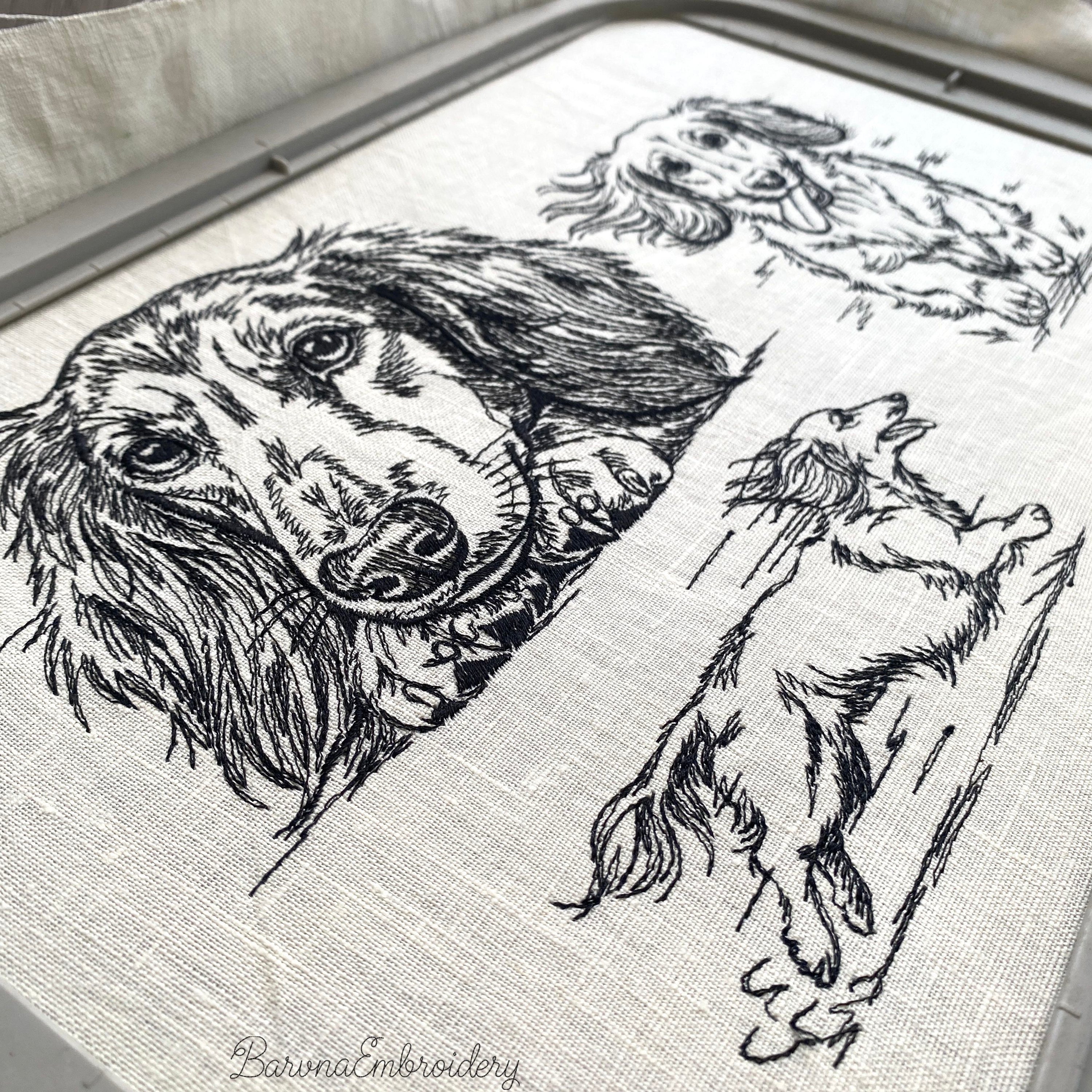 Black and white embroidered illustration of a long-haired dachshund dog. The dog is lying down, with its paws and head resting on a surface. The dog's eyes are open, and it has long, flowing fur.