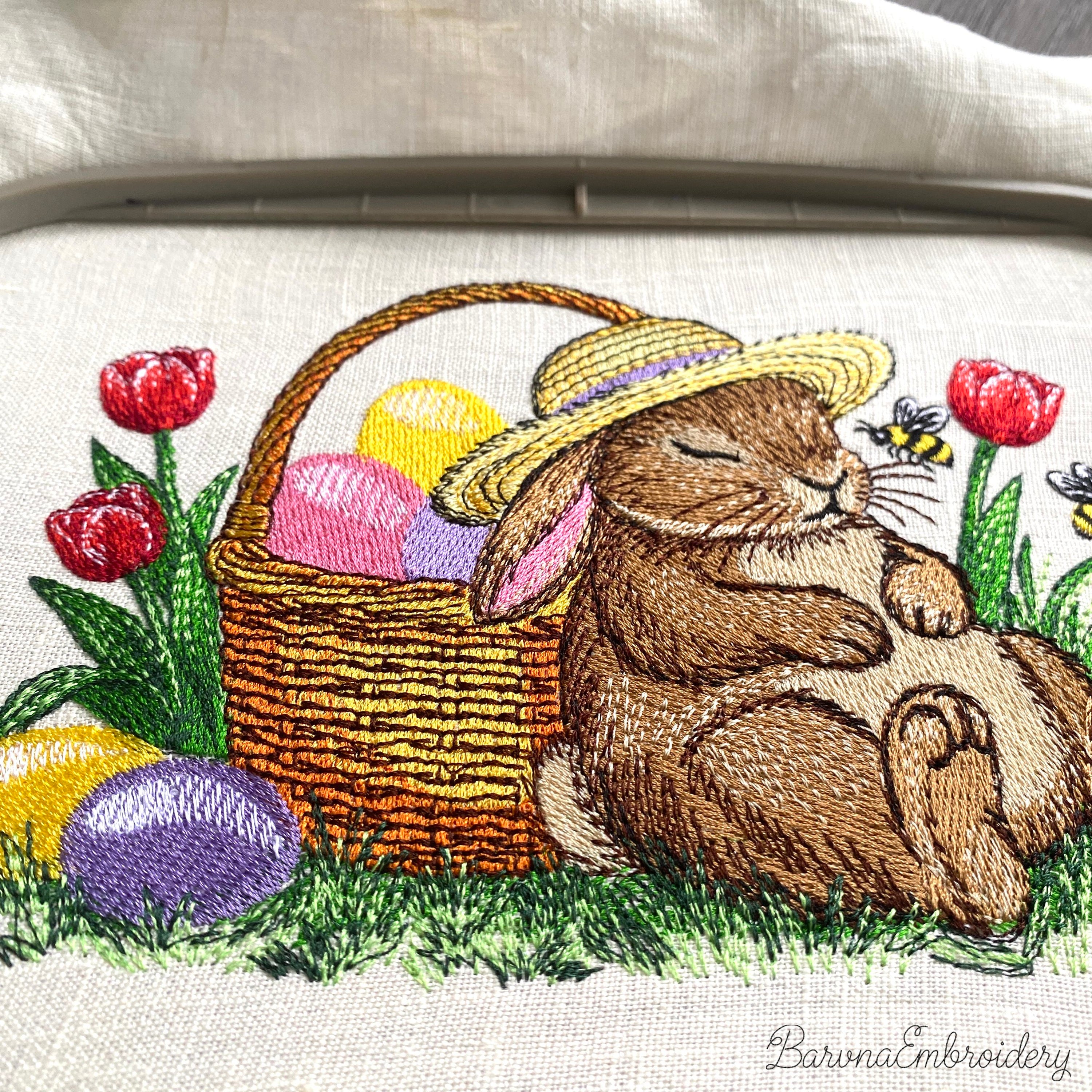 Sleeping Easter bunny machine embroidery design with basket of eggs and spring flowers
