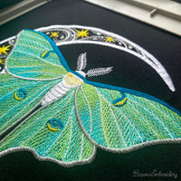 Green luna moth machine embroidery design with crescent moon and stars on dark background