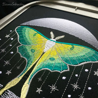 Four luna moth machine embroidery designs with celestial and decorative elements