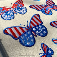Machine embroidery butterfly design with stars and number 250 placed on the wing in patriotic colors.