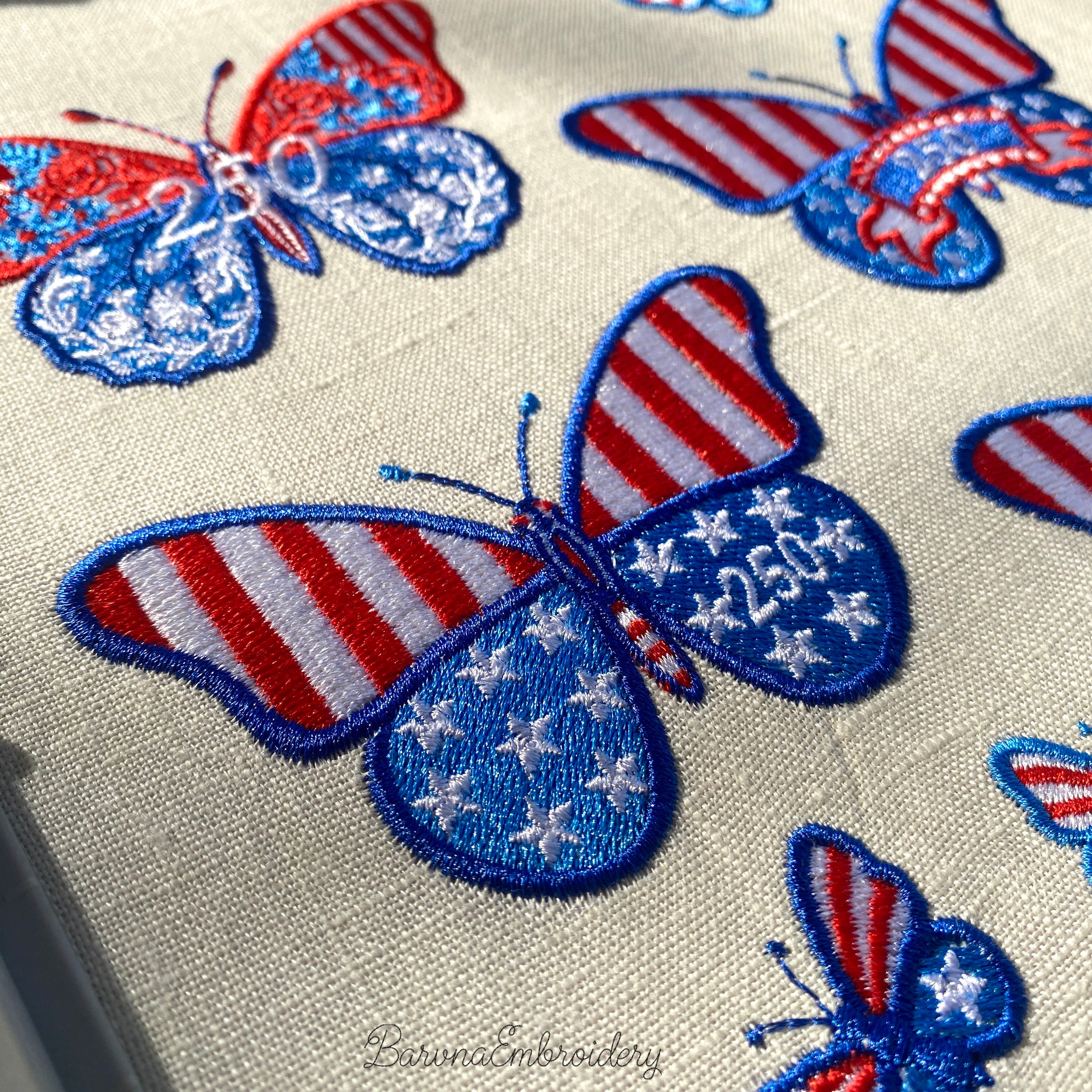 Machine embroidery butterfly design with stars and number 250 placed on the wing in patriotic colors.
