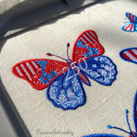 Patriotic butterfly machine embroidery design with floral ornament in USA flag colors and number 250.