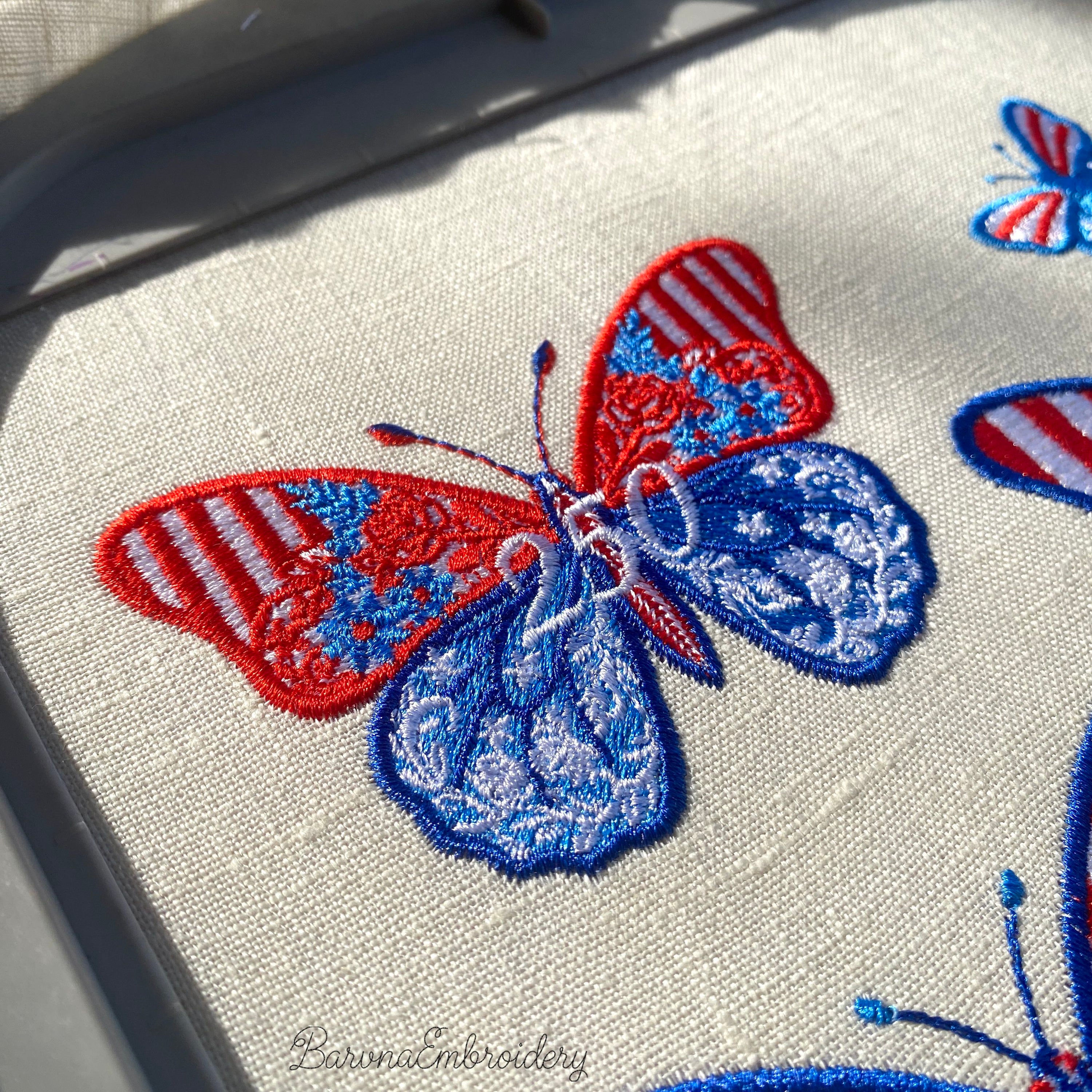 Patriotic butterfly machine embroidery design with floral ornament in USA flag colors and number 250.