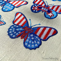 Patriotic butterfly machine embroidery design with decorative stars and number detail.