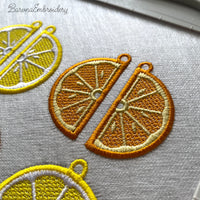 Three pairs of FSL orange embroidery designs — half-slice, whole orange with green leaves, and round citrus cross-section — Free Standing Lace machine embroidery pattern for earrings and pendants.