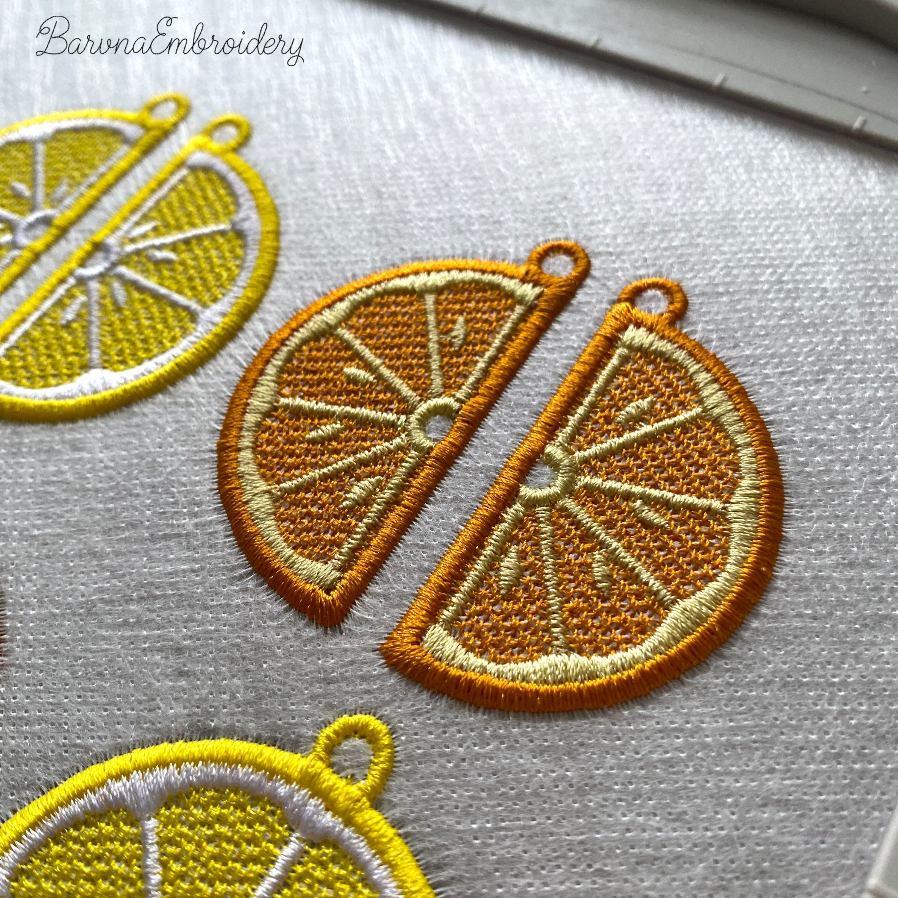 Three pairs of FSL orange embroidery designs — half-slice, whole orange with green leaves, and round citrus cross-section — Free Standing Lace machine embroidery pattern for earrings and pendants.