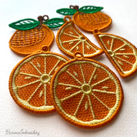 Three pairs of FSL orange embroidery designs — half-slice, whole orange with green leaves, and round citrus cross-section — Free Standing Lace machine embroidery pattern for earrings and pendants.