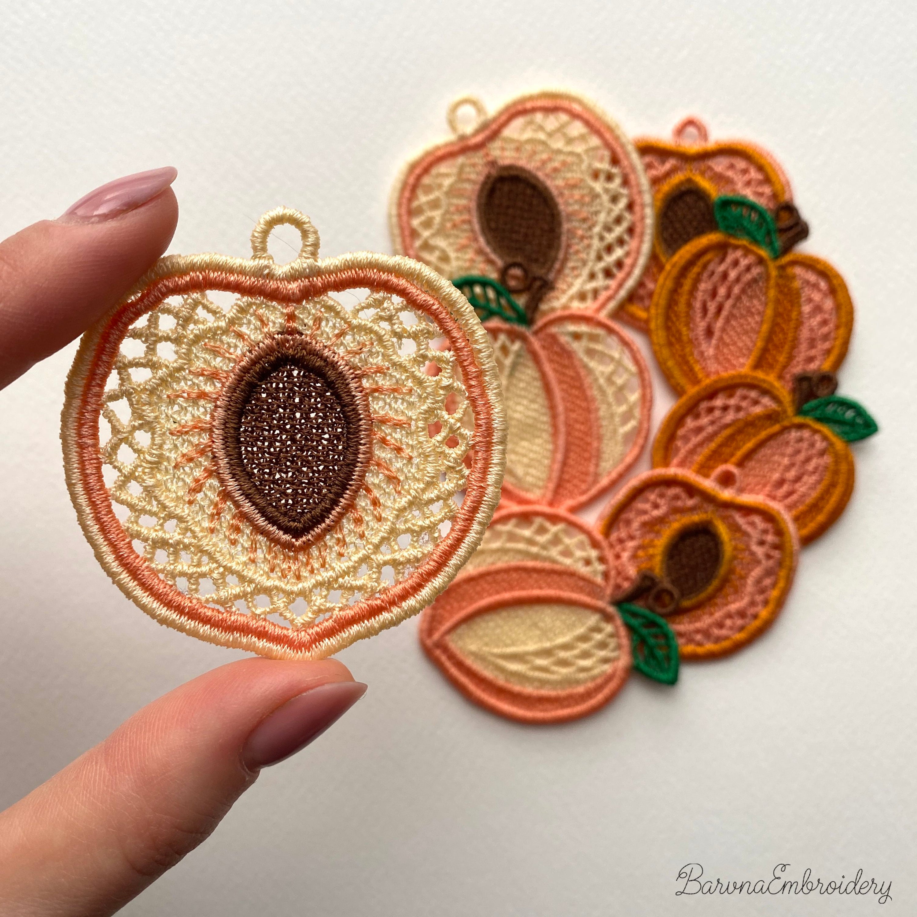 FSL peach embroidery designs in two styles — symmetrical peach half with stone center and whole peach with green leaf — shown as mirrored pairs, Free Standing Lace machine embroidery pattern for earrings and pendants.