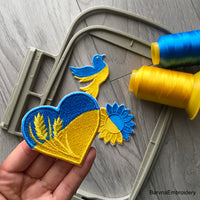Heart-shaped Ukrainian flag embroidery with wheat stalks and satin border – perfect as a patch or for decorating clothes and bags.
