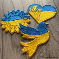 Ukrainian flag embroidery design shaped like a dove with a satin border – ideal for patches or stitching on shirts, bags, or decor.
