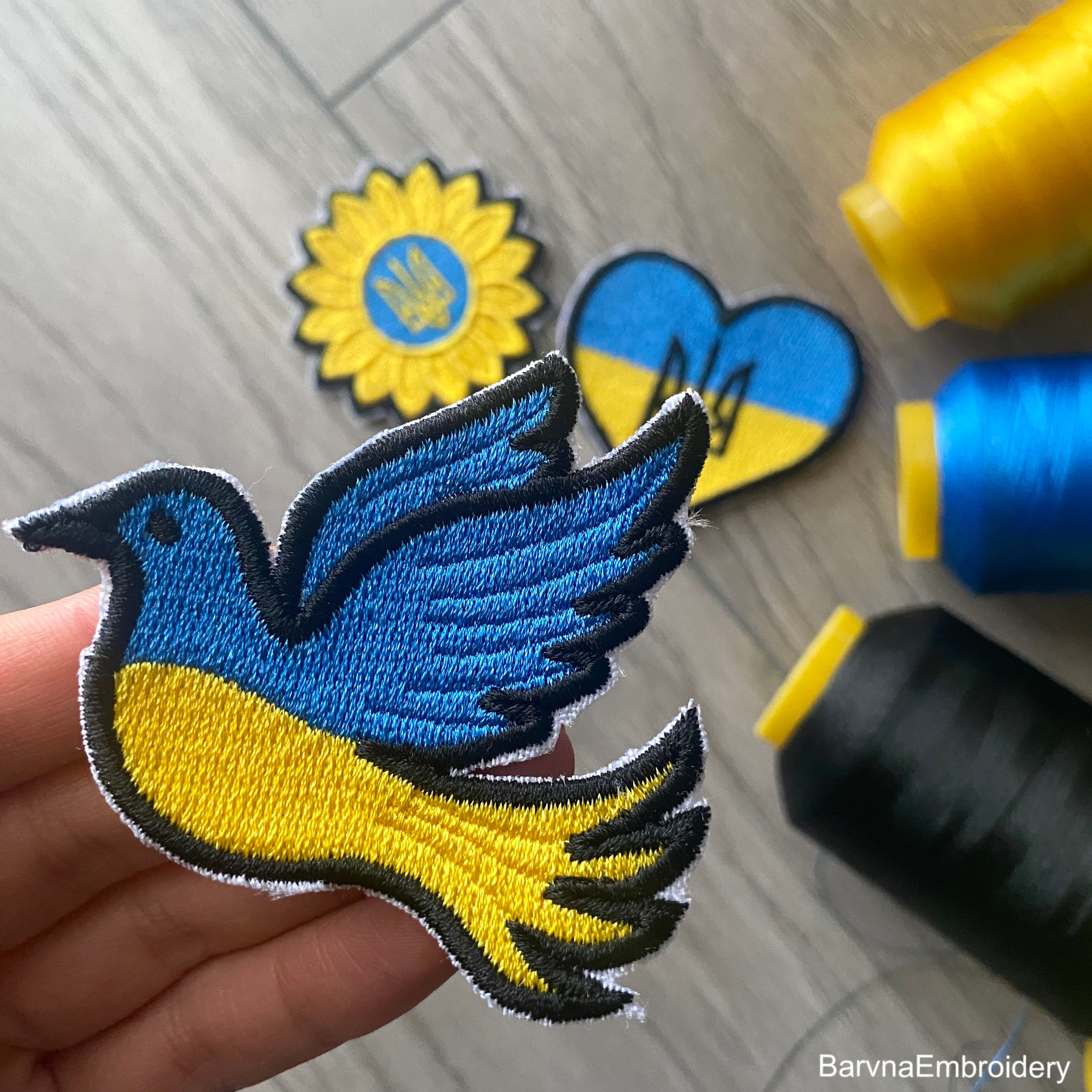 Ukrainian flag embroidery design shaped like a dove with a satin border – ideal for patches or stitching on shirts, bags, or decor.