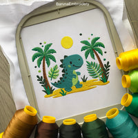 Cute dinosaur embroidery design with palm tree, sand, and sun – perfect for boys’ clothing or nursery decor.