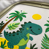 Cute dinosaur embroidery design with palm tree, sand, and sun – perfect for boys’ clothing or nursery decor.
