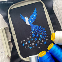 Machine embroidery design of a flying dove with flowers and stars trailing from its tail.