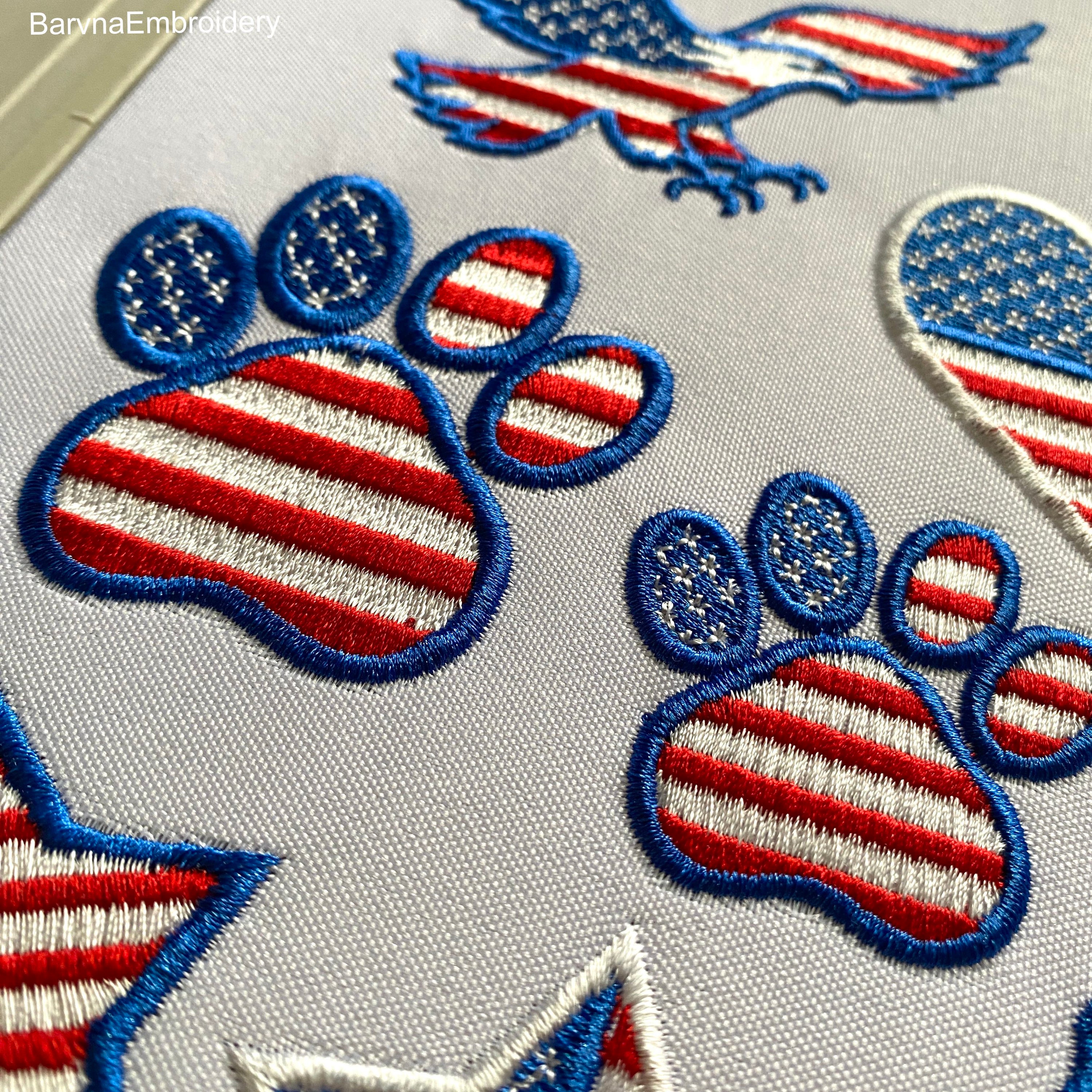 Machine embroidery design of a paw with the American flag inside, great for patriotic pet lovers.