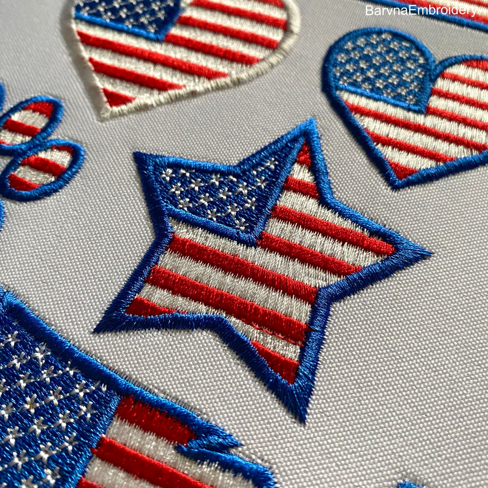 Set of 6 USA-themed machine embroidery designs: map, flag, heart, star, paw print, and eagle, all in American flag style.
