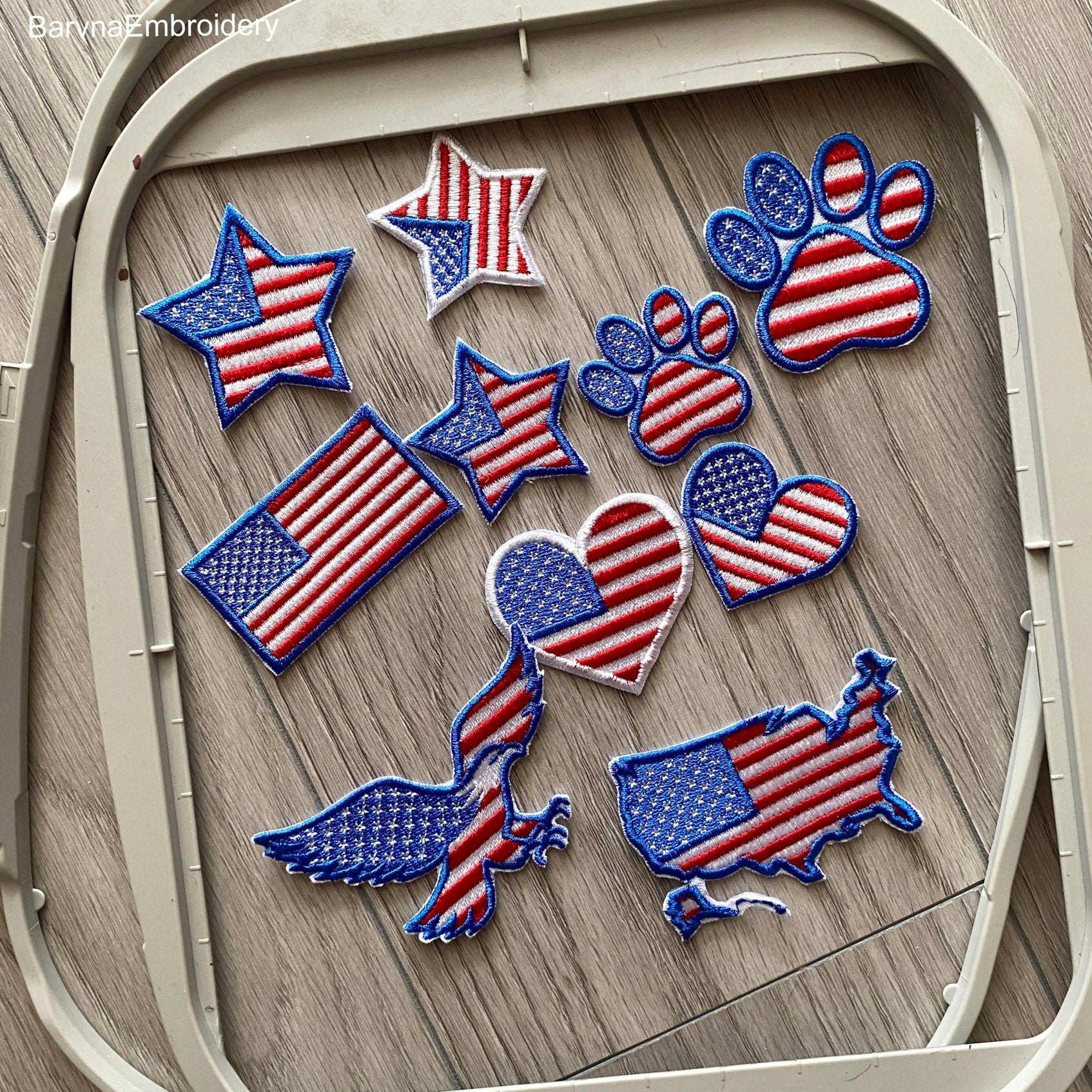 Set of 6 USA-themed machine embroidery designs: map, flag, heart, star, paw print, and eagle, all in American flag style.