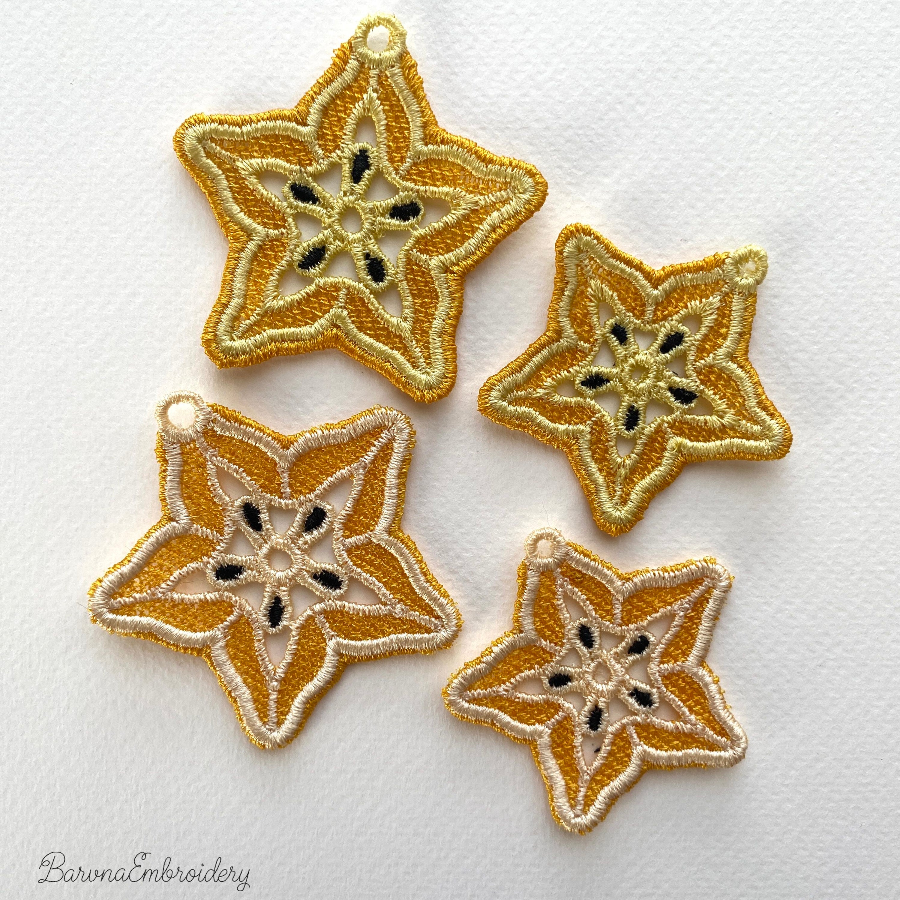 FSL carambola star fruit embroidery designs in two sizes — warm gold lace star shape with cream inner pattern and dark seed details — finished stitched results, Free Standing Lace machine embroidery pattern for earrings and pendants.