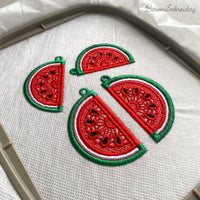 Two mirrored FSL watermelon slice earrings — a machine embroidery design in Free Standing Lace technique, showing red lace fill, black seeds, and green border with a hanging loop.