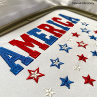 Machine embroidery design featuring the word “America” in bold red and blue letters with scattered red, white, and blue stars below, perfect for patriotic projects.