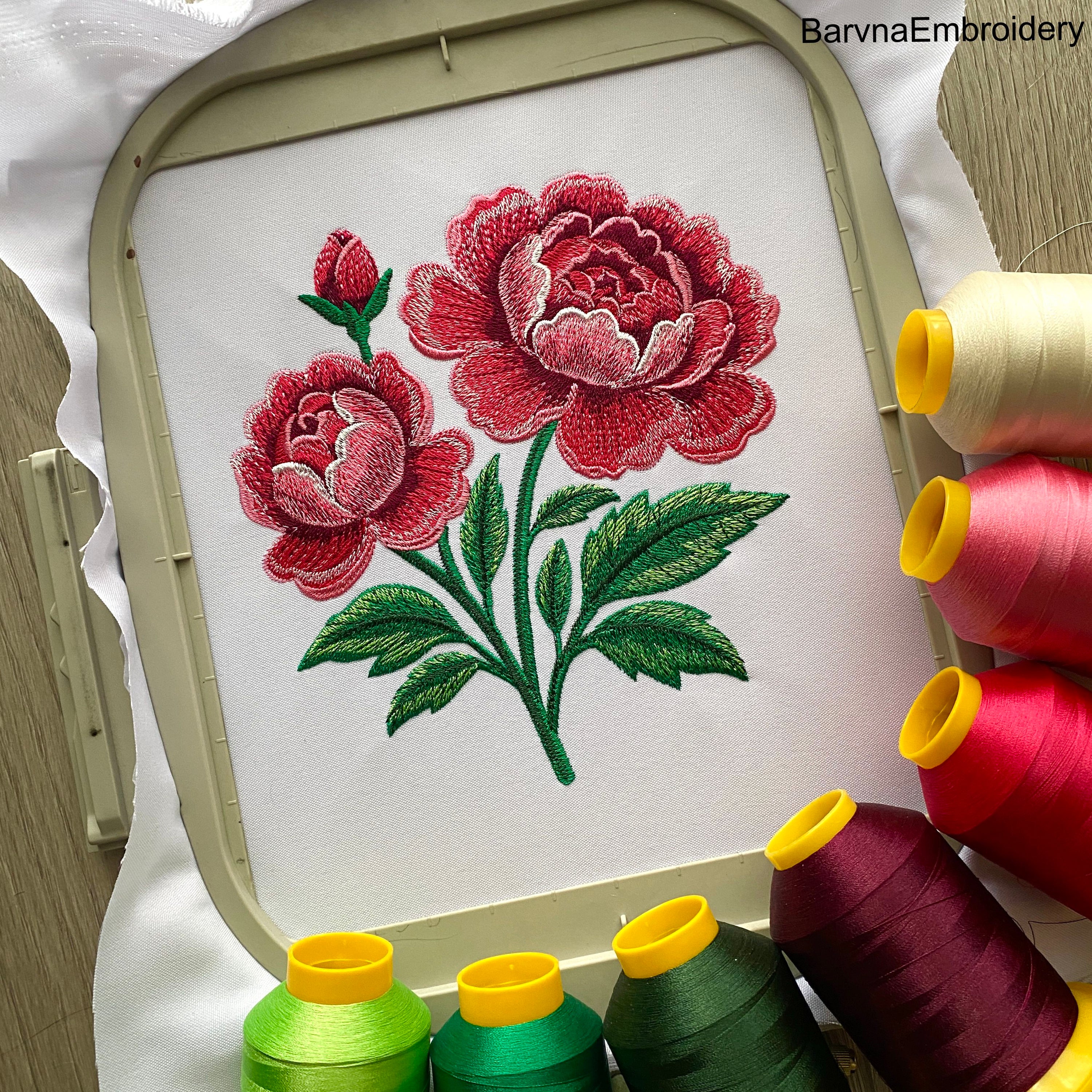Machine embroidery design of blooming pink peonies with green leaves and a flower bud. Detailed satin and tatami stitches for elegant floral projects.