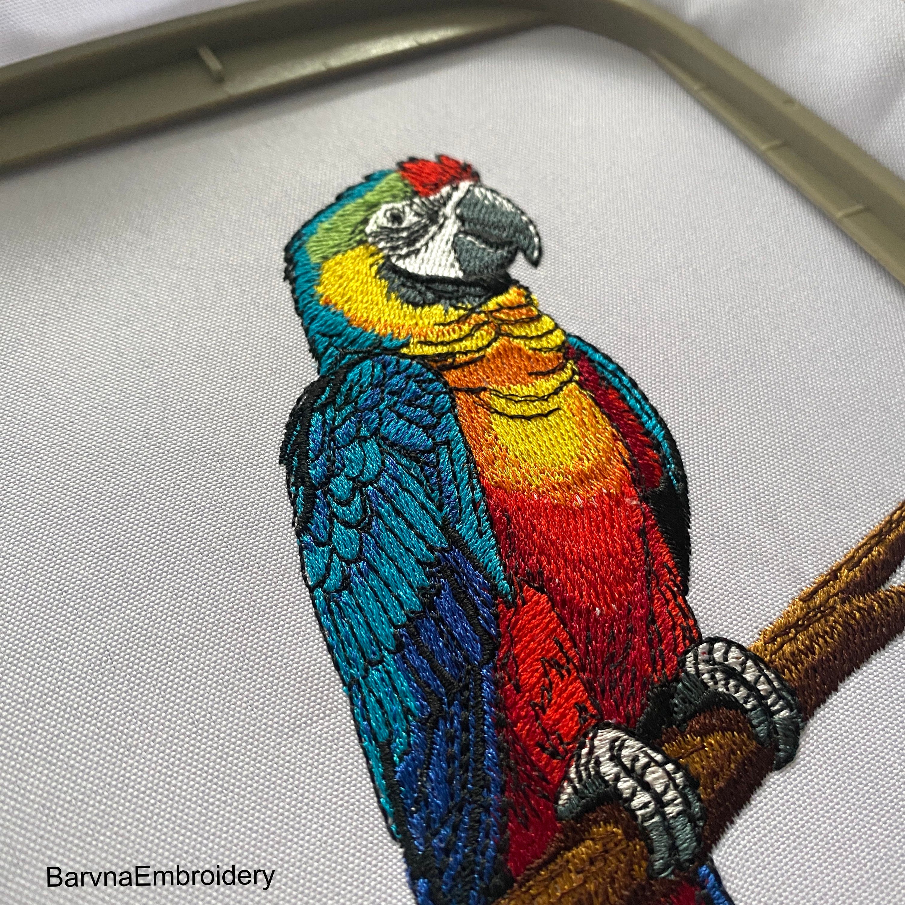 Colorful macaw parrot machine embroidery design sitting on a branch, digital file for embroidery machines.