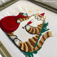 Festive Christmas embroidery design with a funny Santa cat – digital file for holiday machine embroidery projects.