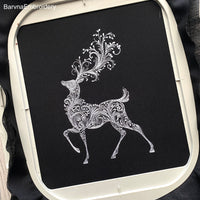 Elegant deer embroidery design with swirl pattern – one-color machine embroidery file for Christmas and winter projects.