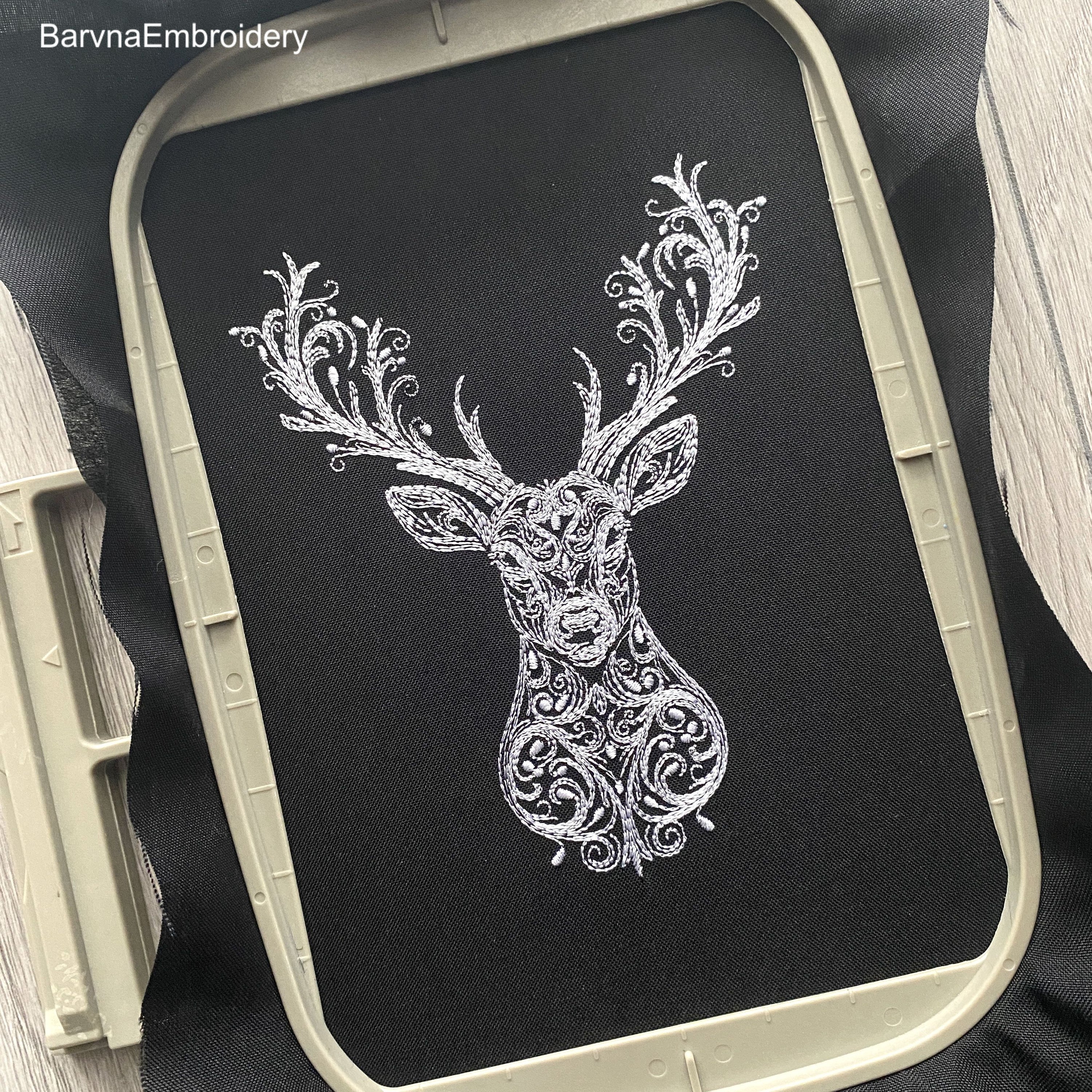 Deer head embroidery design with swirl details – one-color digital machine embroidery file for holiday and winter projects.