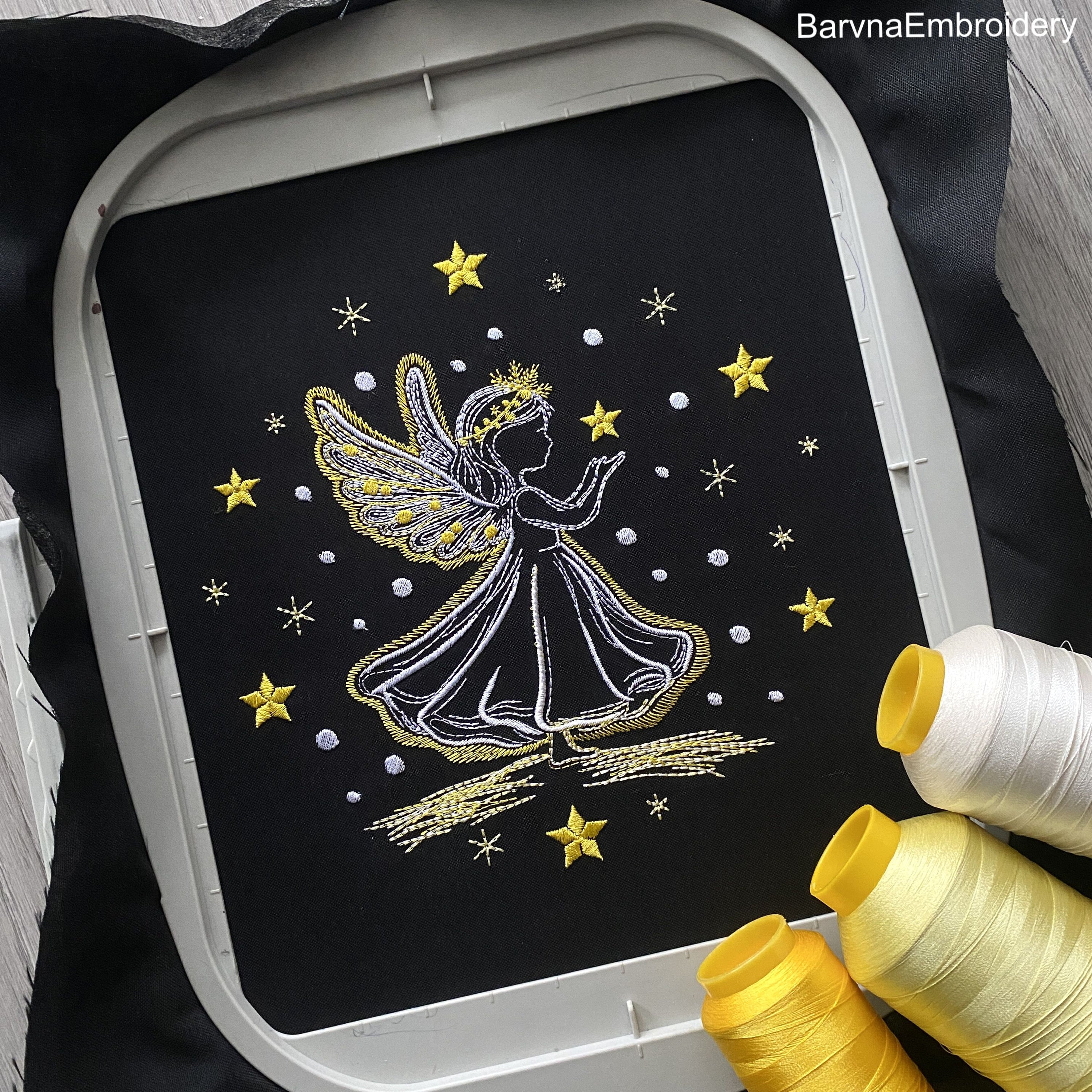 Machine embroidery design of angel girl holding a star, surrounded by sparkling stars, ideal for Christmas or baby projects.