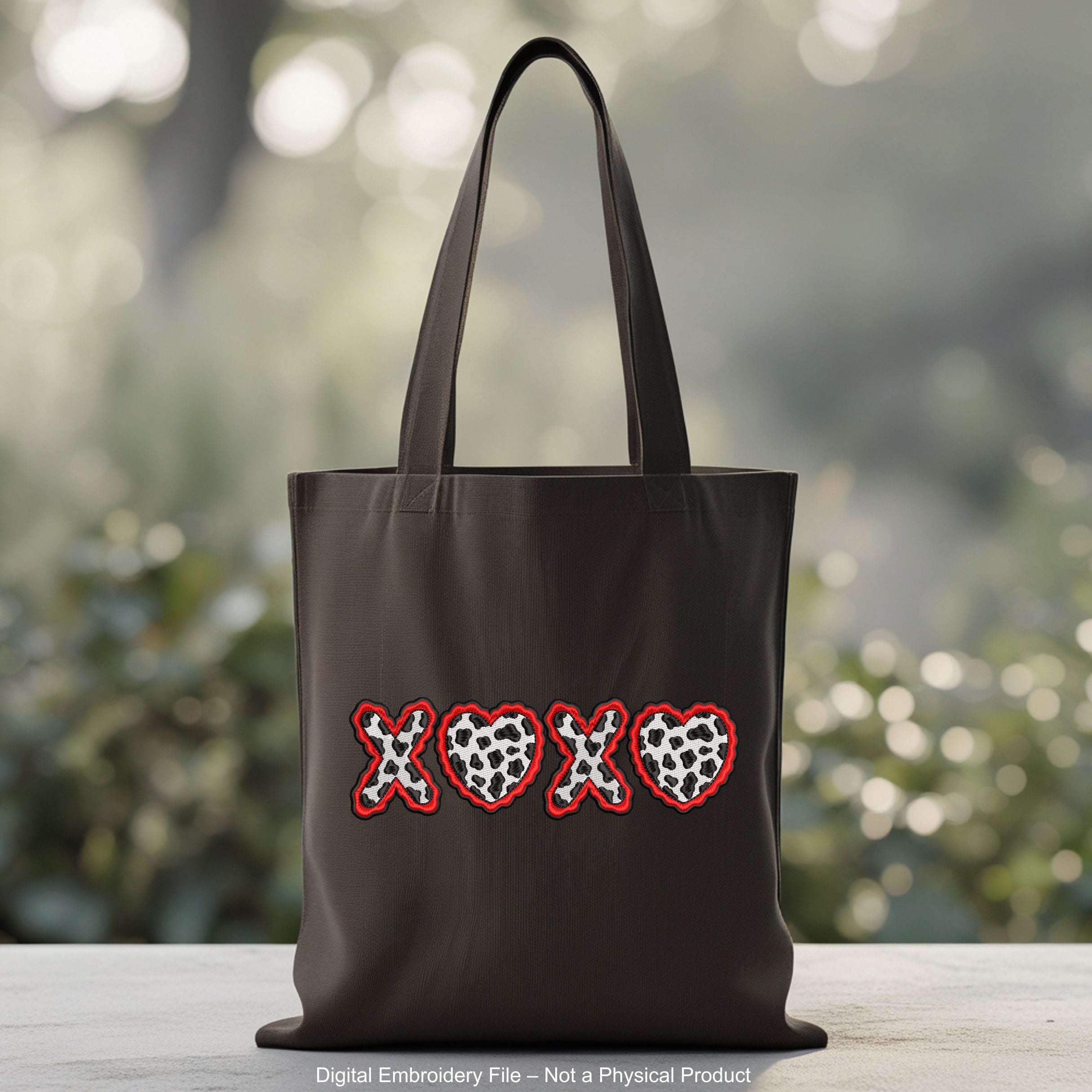 Machine embroidery design of the letters XOXO where both O characters are replaced by cow print hearts with wavy red borders.