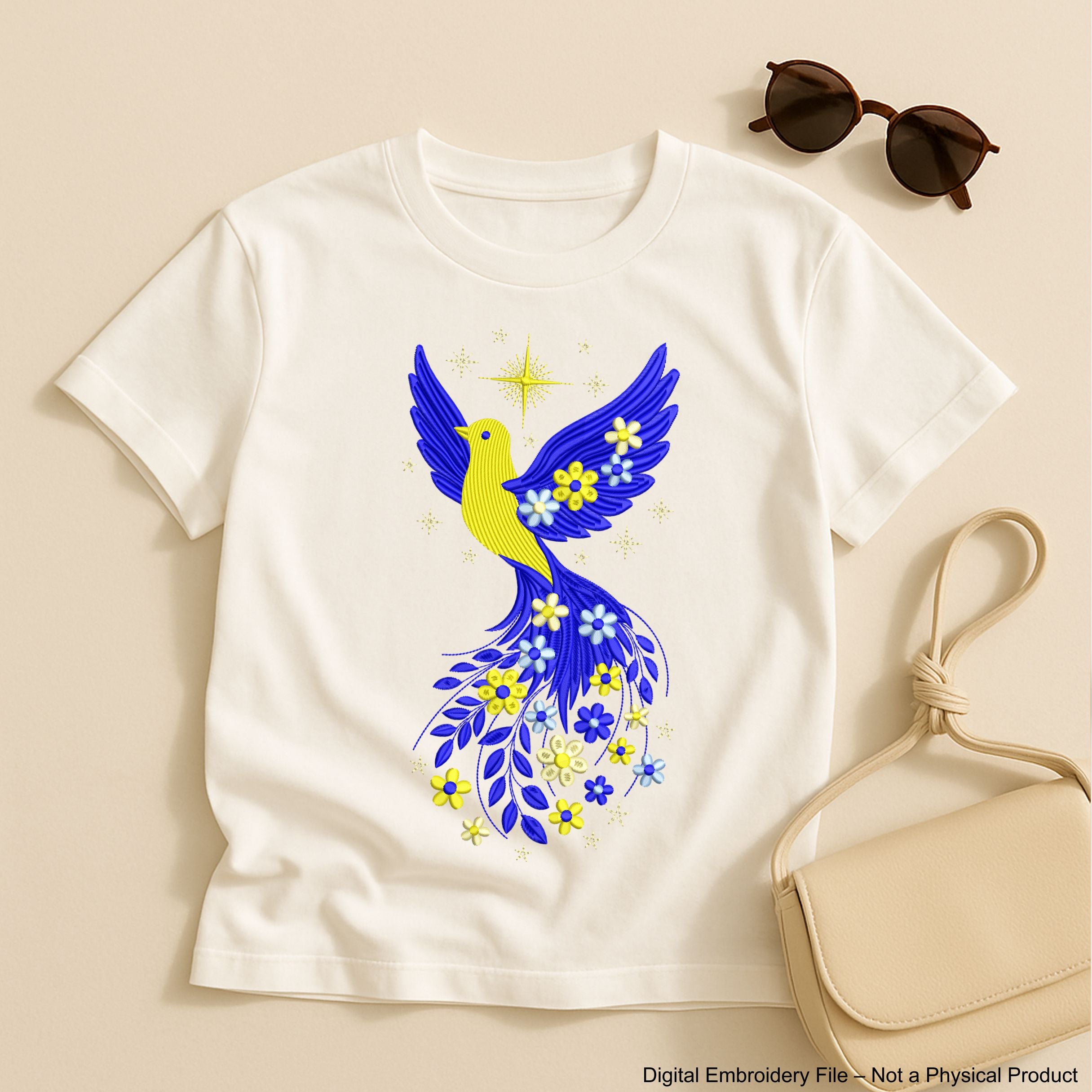 Blue and yellow flying bird embroidery design with stars and flowers trailing from wings – symbolic Ukrainian patriotic motif.