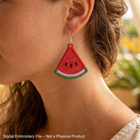 Two mirrored FSL watermelon slice earrings — a machine embroidery design in Free Standing Lace technique, showing red lace fill, black seeds, and green border with a hanging loop.