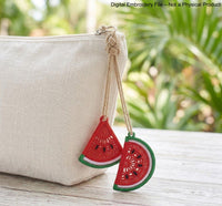 Two mirrored FSL watermelon slice earrings — a machine embroidery design in Free Standing Lace technique, showing red lace fill, black seeds, and green border with a hanging loop.