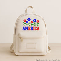 Machine embroidery design of the word “America” decorated with red, white, and blue flowers, perfect for patriotic crafts and 4th of July projects.
