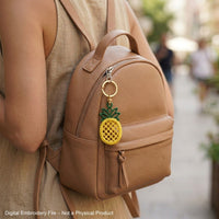 FSL pineapple embroidery design previews — yellow lace body with green crown and hanging loop — Free Standing Lace machine embroidery pattern for earrings and pendants.
