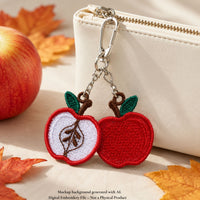 Apple FSL keychain with whole and sliced apple charms attached to a silver lobster clasp