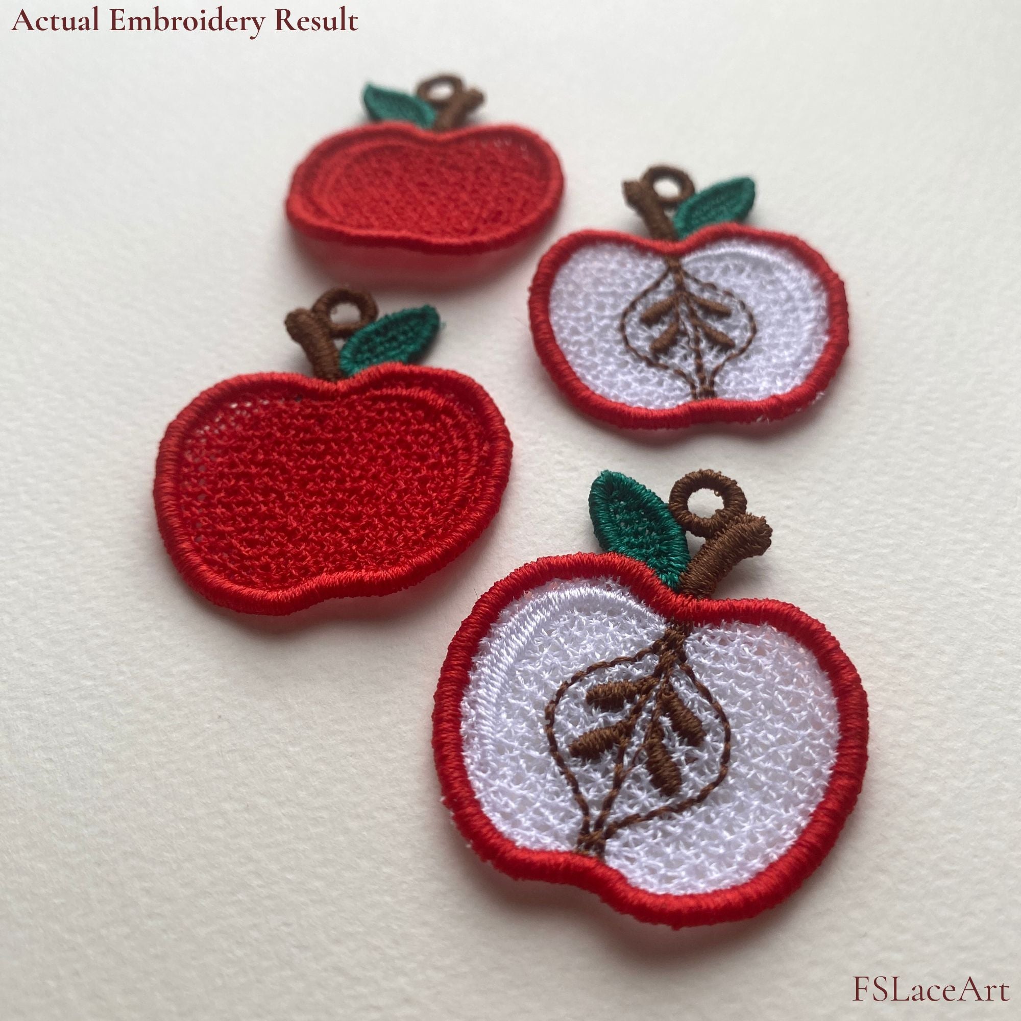 Four finished Apple FSL embroidery pieces showing whole red apples and sliced apples with hanging loops
